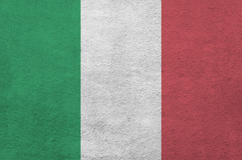 Italy flag depicted in bright paint colors on old relief plastering wall close up