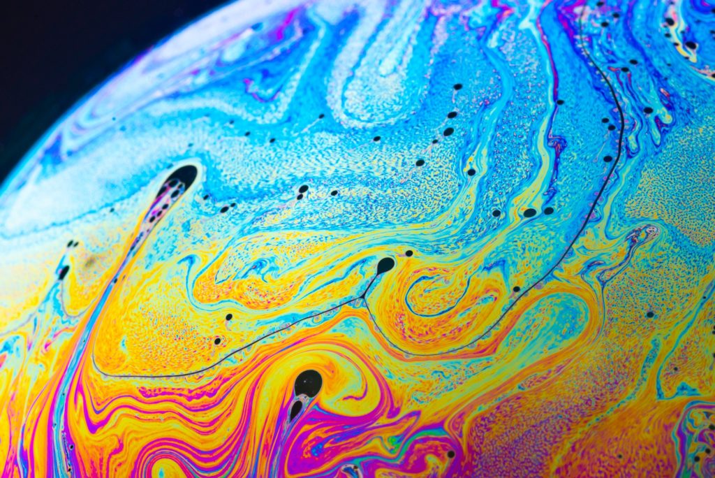 Rainbow soap bubble on a dark background